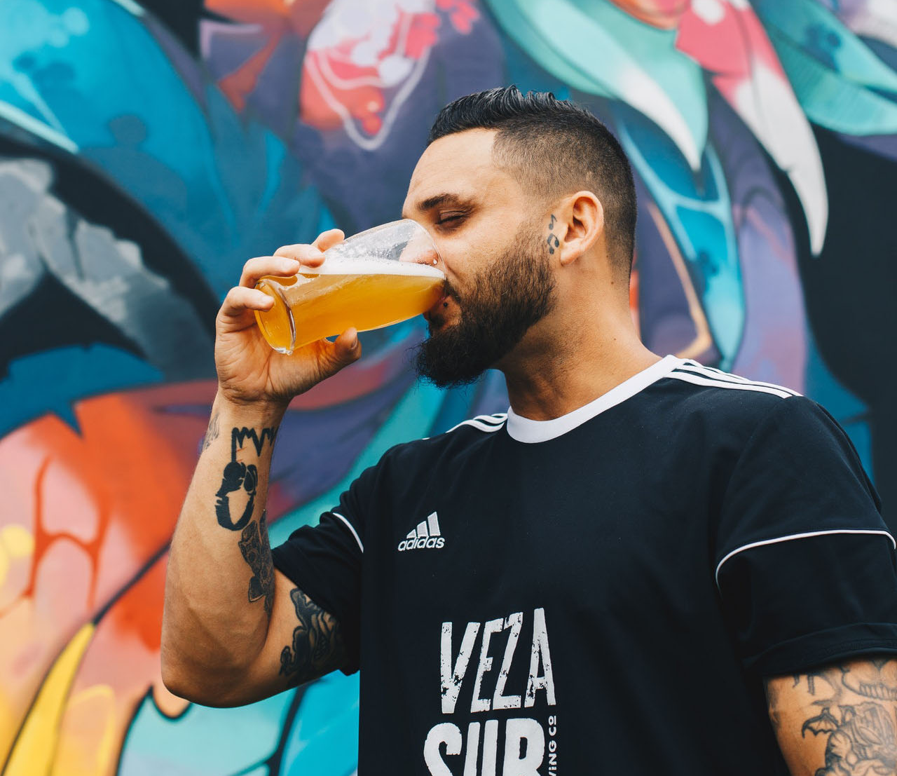 bearded guy drinking a pint