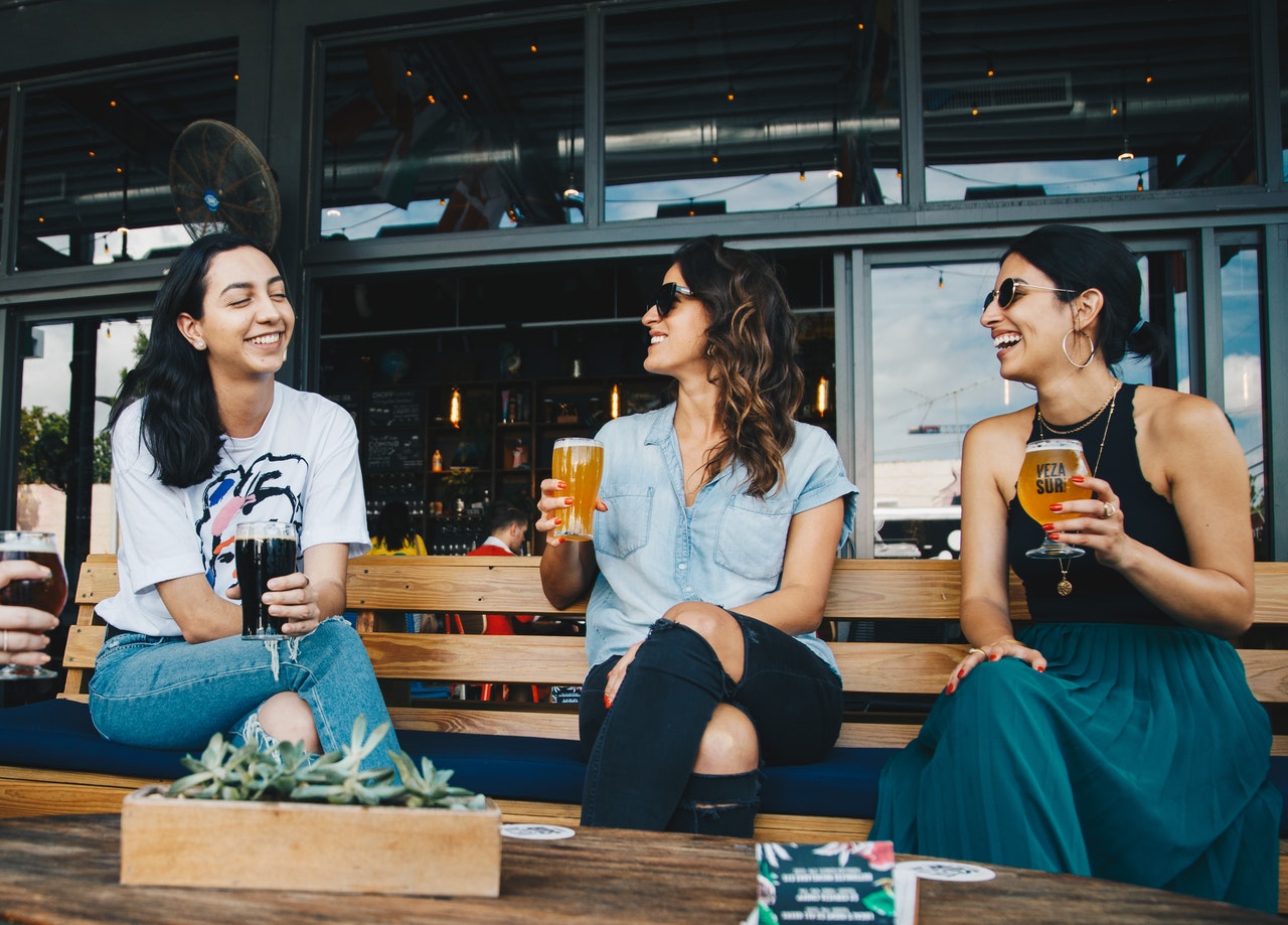 women enyoing a beer pint in a terrase